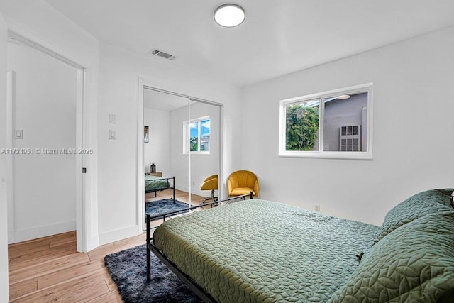 bedroom featuring hardwood / wood-style floors and a closet