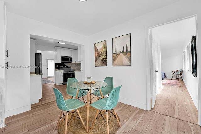 dining area with light hardwood / wood-style floors