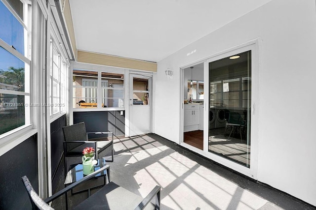 sunroom featuring washing machine and dryer