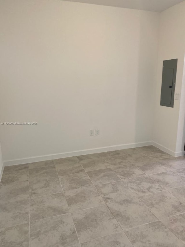 tiled spare room featuring electric panel