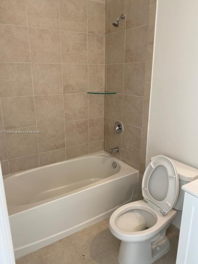 full bathroom with vanity, tile patterned floors, tiled shower / bath combo, and toilet