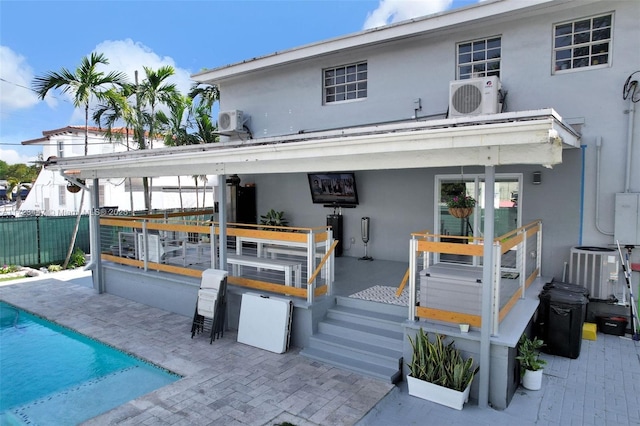 rear view of house with ac unit, central AC, and a patio area