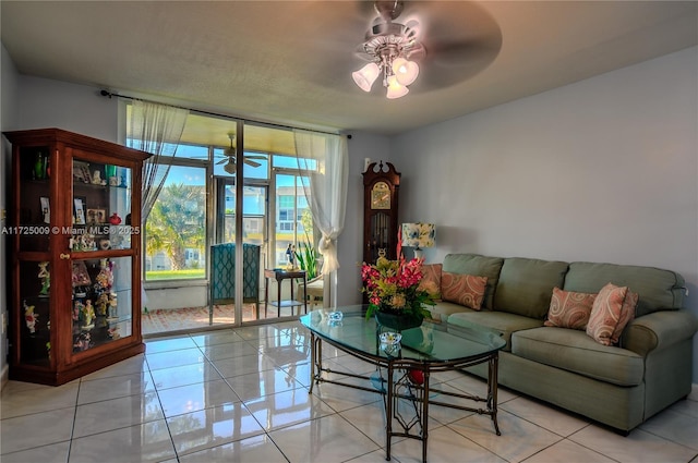 living room with ceiling fan and light tile patterned floors