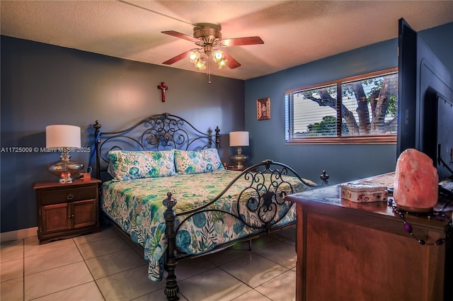 bedroom with a textured ceiling, ceiling fan, and light tile patterned floors