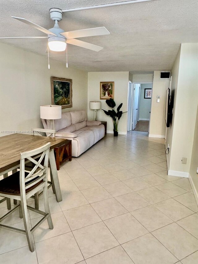 tiled living room featuring ceiling fan