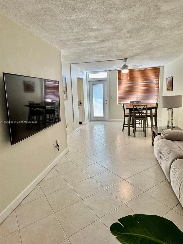 unfurnished bedroom featuring a textured ceiling, ceiling fan, light hardwood / wood-style flooring, and a closet