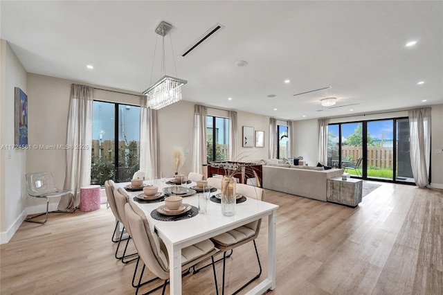 dining room with a chandelier and light wood-type flooring