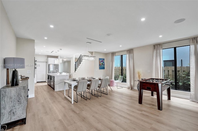 dining space with light hardwood / wood-style flooring and sink