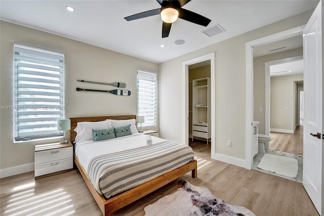 bedroom featuring ceiling fan, light hardwood / wood-style flooring, and ensuite bathroom