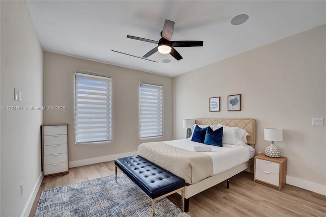 bedroom with ceiling fan and light hardwood / wood-style floors