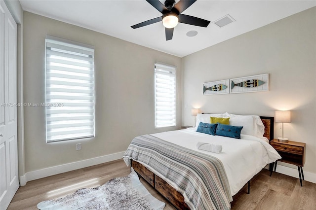 bedroom featuring ceiling fan, a closet, and light wood-type flooring