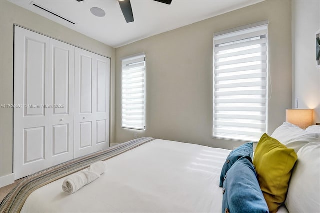 bedroom with ceiling fan and a closet