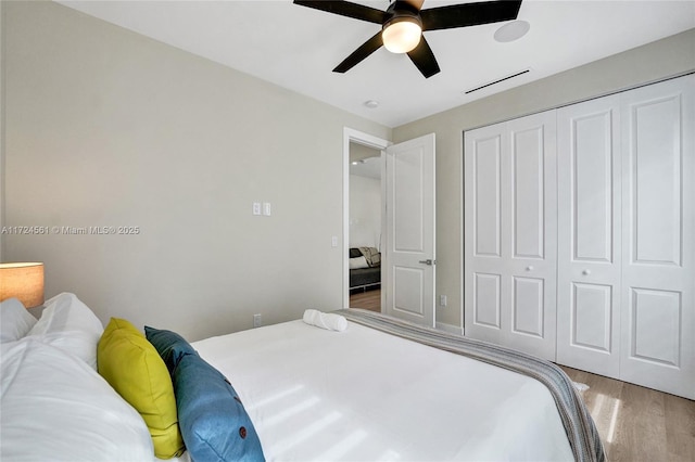 bedroom featuring ceiling fan, a closet, and hardwood / wood-style floors