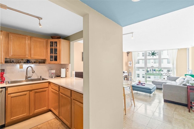 kitchen with tasteful backsplash, sink, light tile patterned floors, and stainless steel dishwasher