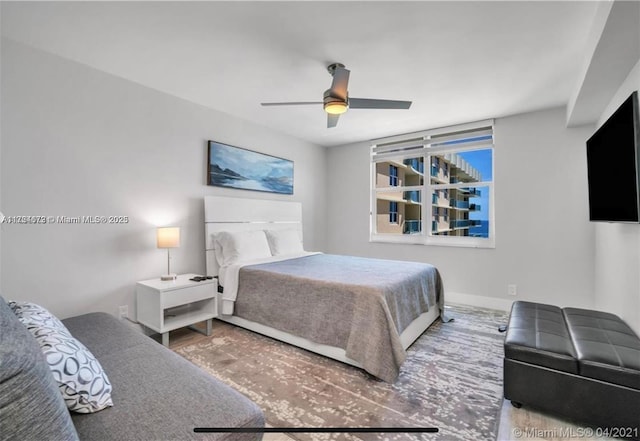 bedroom with hardwood / wood-style floors and ceiling fan