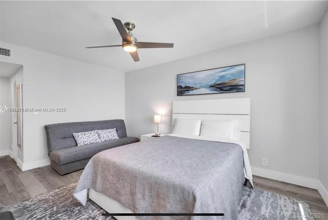 bedroom with ceiling fan and wood-type flooring