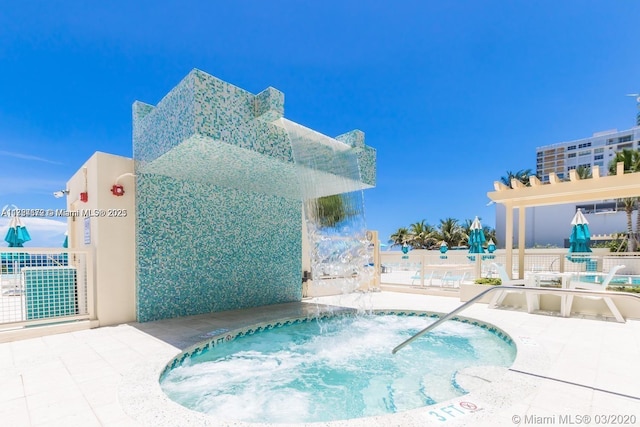 view of pool with a community hot tub and a patio