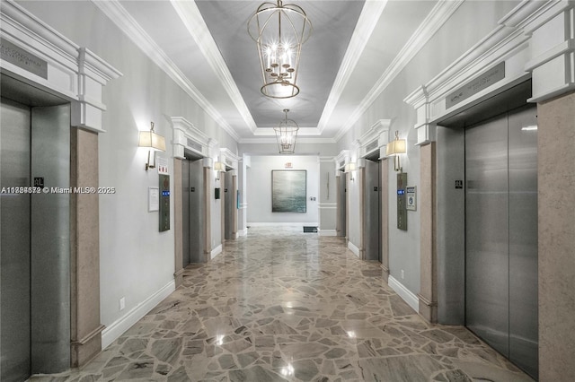 corridor with a chandelier, ornamental molding, elevator, and a tray ceiling