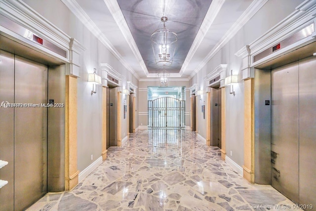 corridor with a tray ceiling, elevator, and crown molding