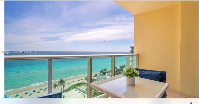 balcony with a view of the beach and a water view