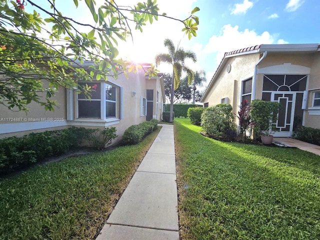 view of property's community with a lawn