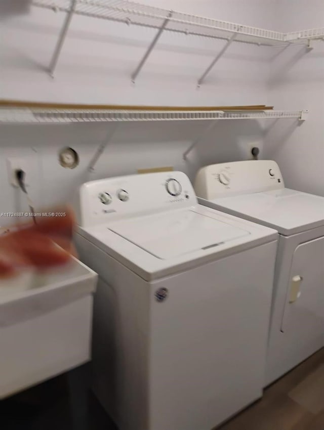 laundry room with washing machine and dryer and sink