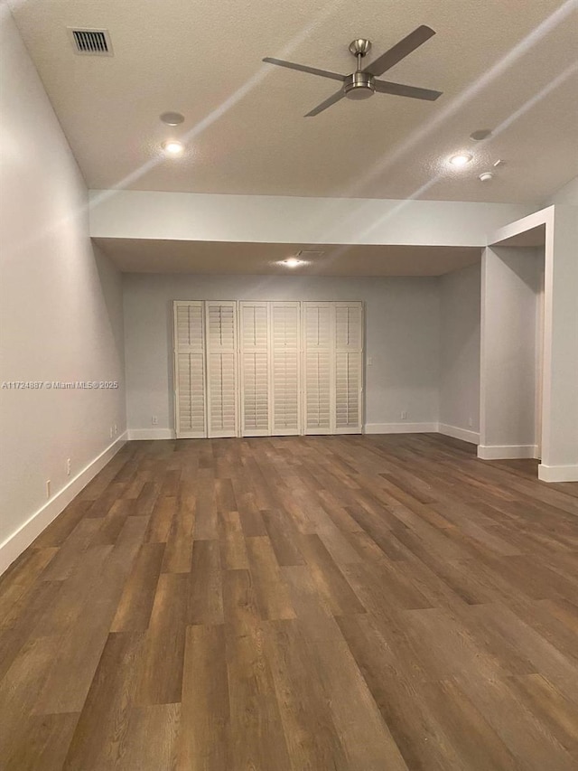 interior space featuring baseboards, lofted ceiling, a ceiling fan, and dark wood-style flooring