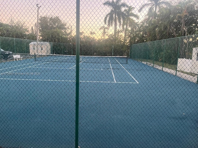 view of tennis court featuring fence