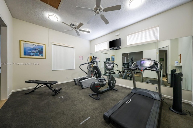 workout area with visible vents, a textured ceiling, carpet floors, baseboards, and ceiling fan
