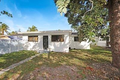 rear view of property featuring a yard