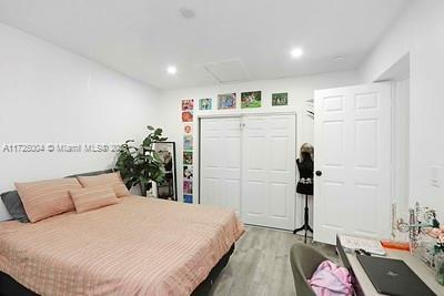 bedroom featuring light hardwood / wood-style floors and a closet