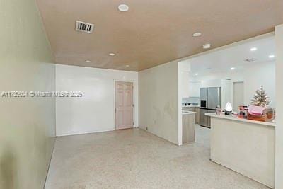 kitchen featuring stainless steel refrigerator with ice dispenser