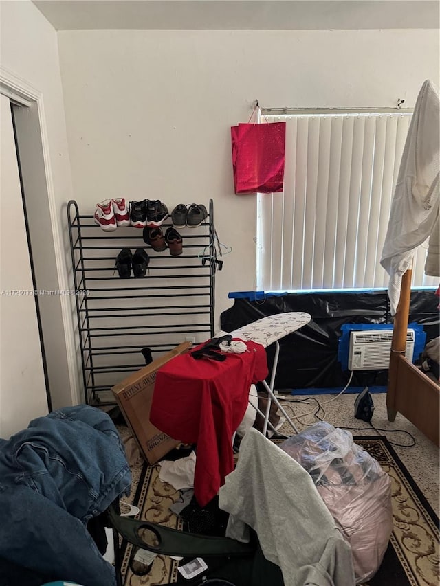 miscellaneous room featuring a wall unit AC and carpet flooring