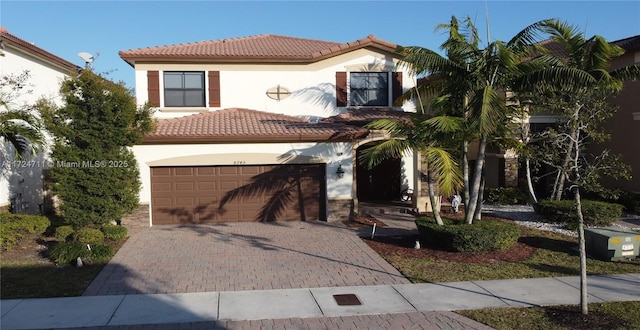 mediterranean / spanish house featuring a garage