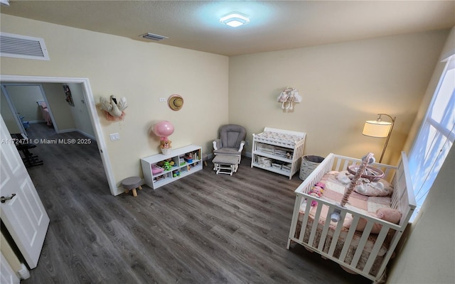 interior space featuring dark hardwood / wood-style flooring and a crib