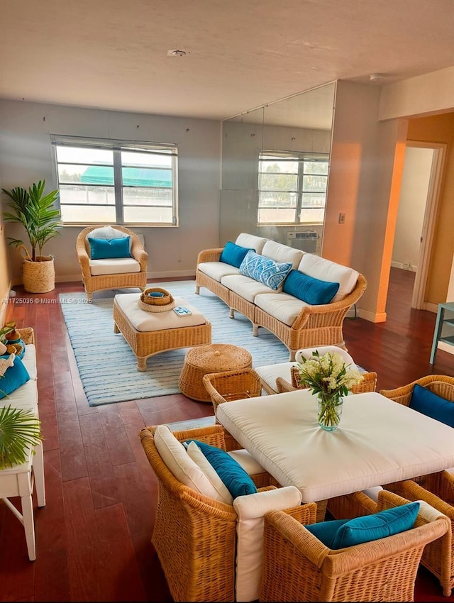 living room featuring plenty of natural light and dark hardwood / wood-style flooring