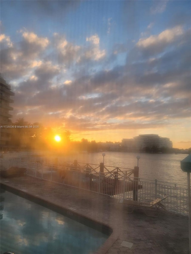 pool at dusk with a water view