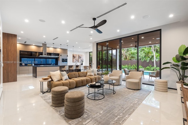 tiled living room with a wall of windows and ceiling fan