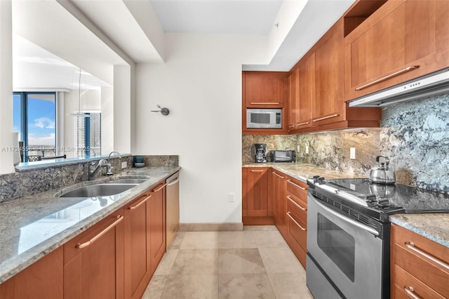 kitchen featuring sink, light stone counters, backsplash, light tile patterned flooring, and appliances with stainless steel finishes