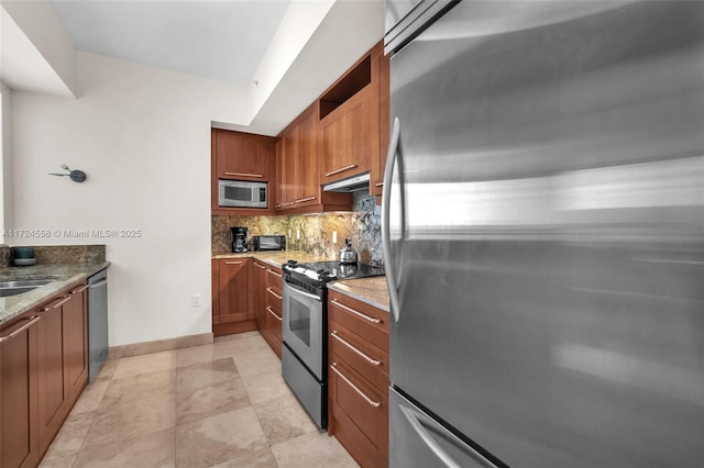 kitchen with backsplash, sink, light stone countertops, and stainless steel appliances