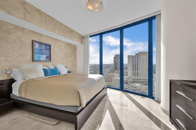 bedroom featuring expansive windows and access to outside