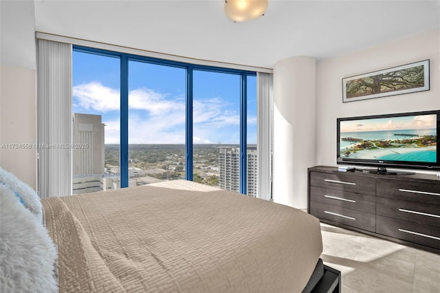 bedroom featuring expansive windows and multiple windows