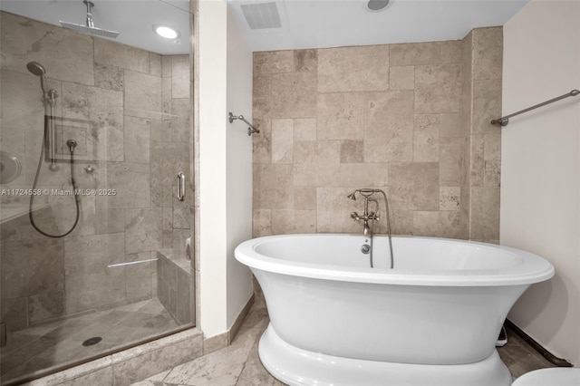 bathroom featuring shower with separate bathtub