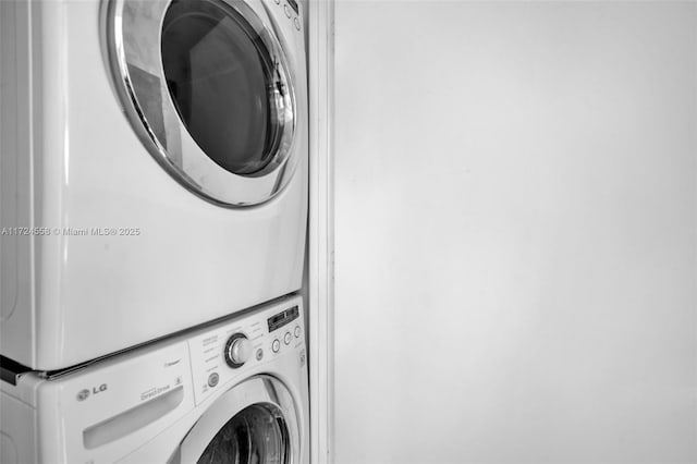 laundry area featuring stacked washing maching and dryer