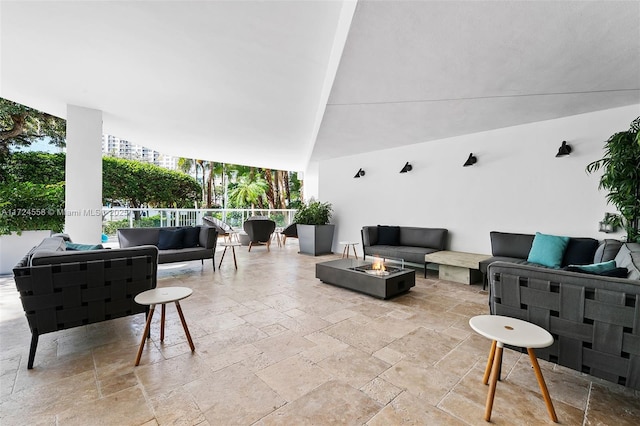 view of patio featuring an outdoor living space with a fire pit