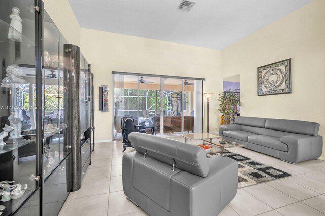 tiled living room with ceiling fan