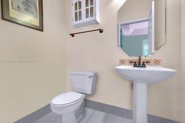 bathroom featuring tile patterned floors and toilet