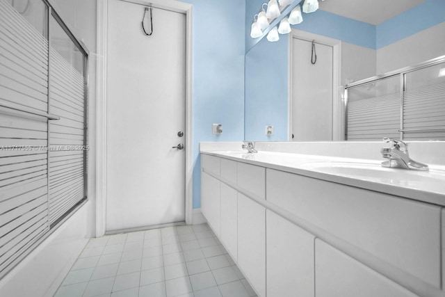 bathroom featuring enclosed tub / shower combo and vanity