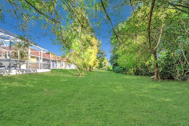 view of yard with glass enclosure