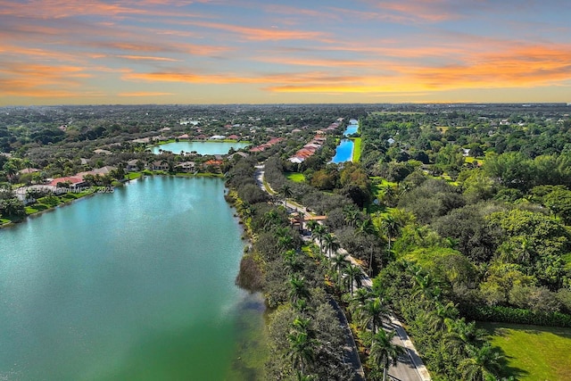 aerial view at dusk with a water view